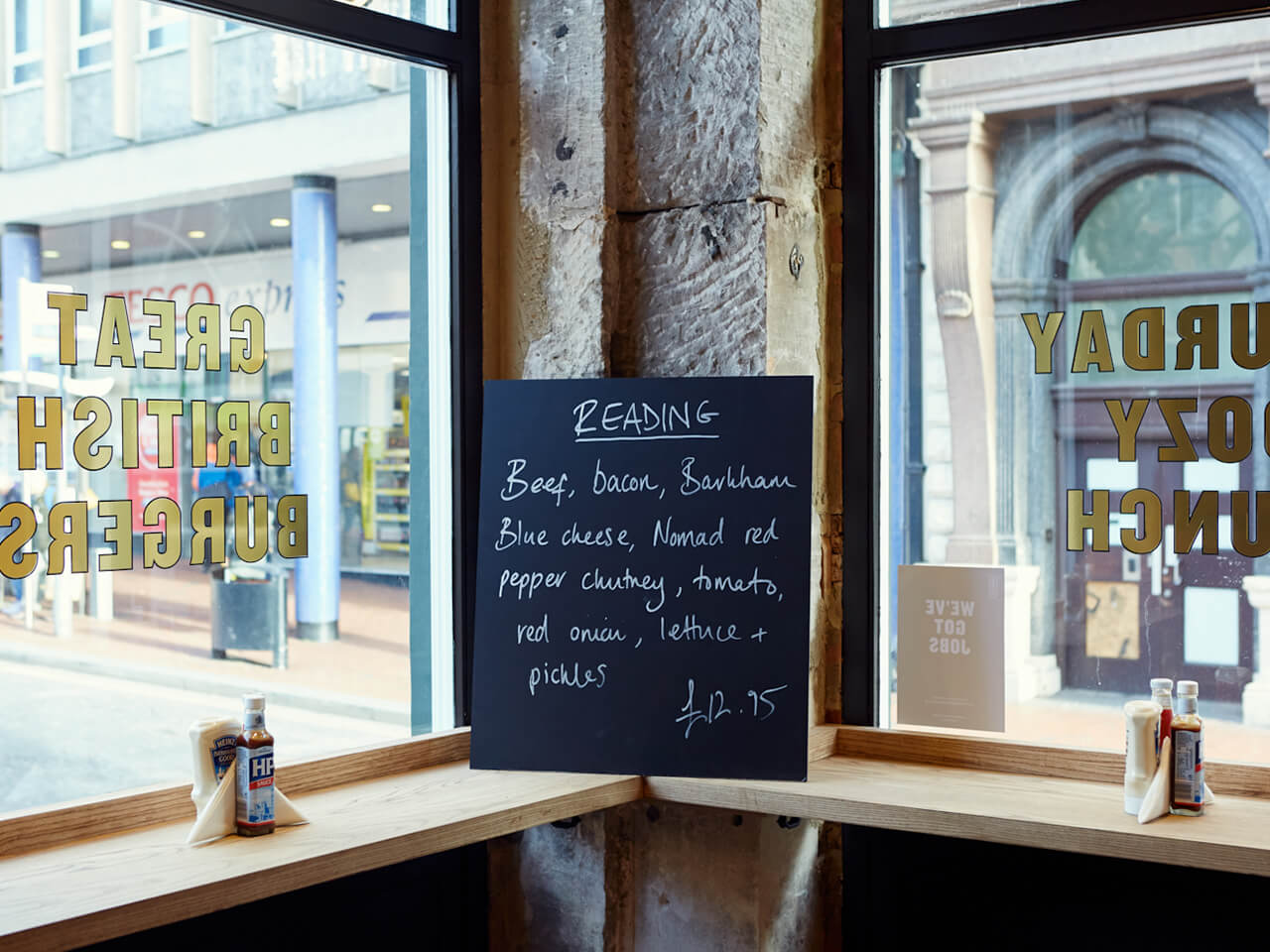 Reading special burger blackboard hanging between two windows inside Honest Burgers Reading