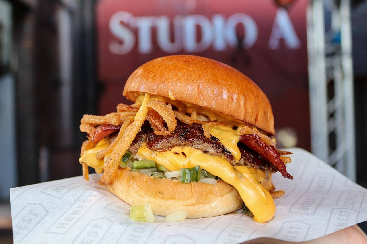 smashed beef patty burger with cheese, bacon and onion test kitchen