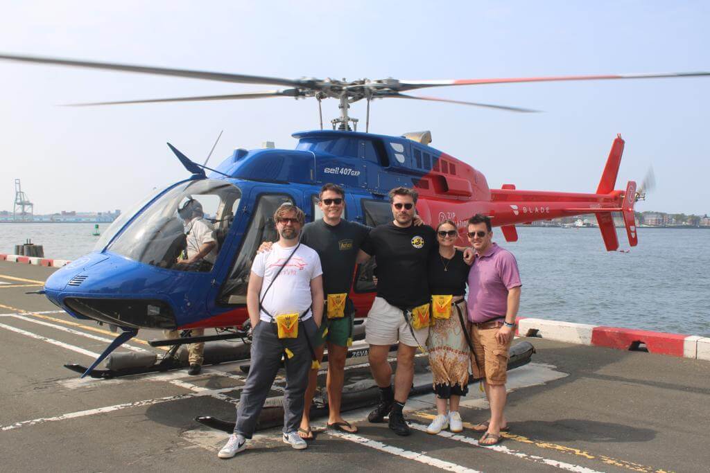 Honest team outside helicopter